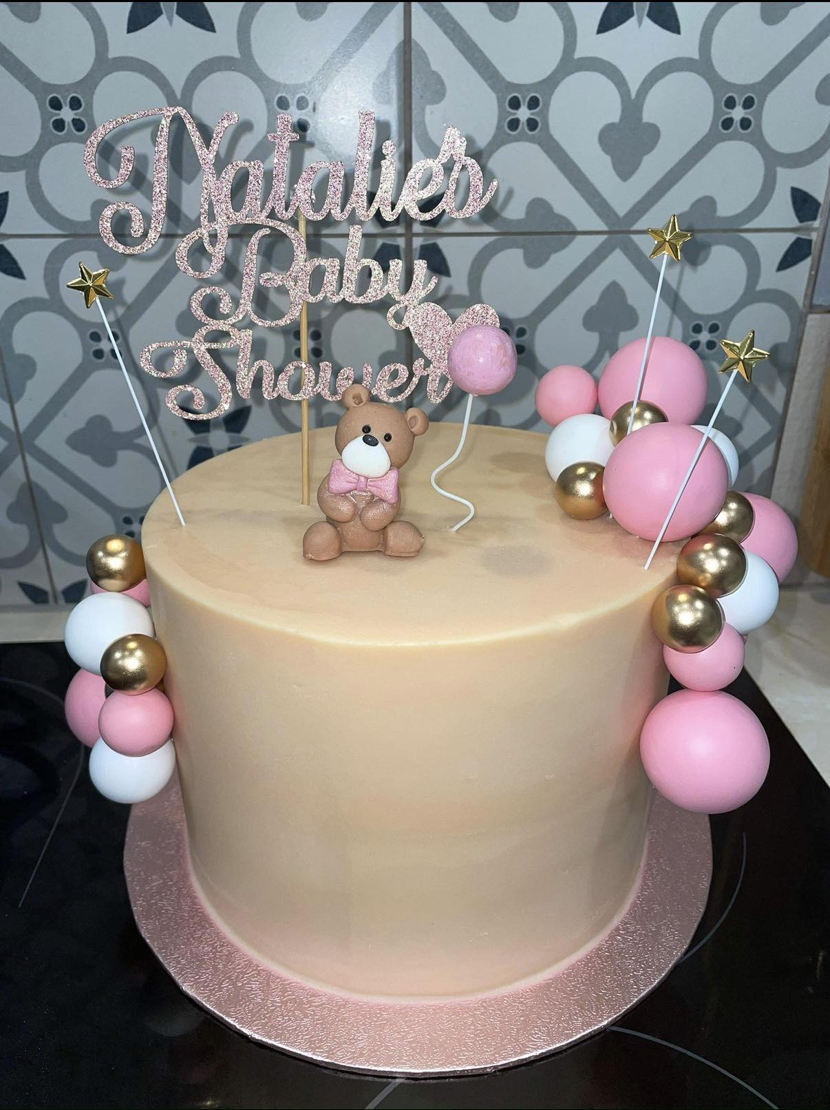 Natalie's Baby Shower cake with a fondant teddy bear and pink and gold balloons