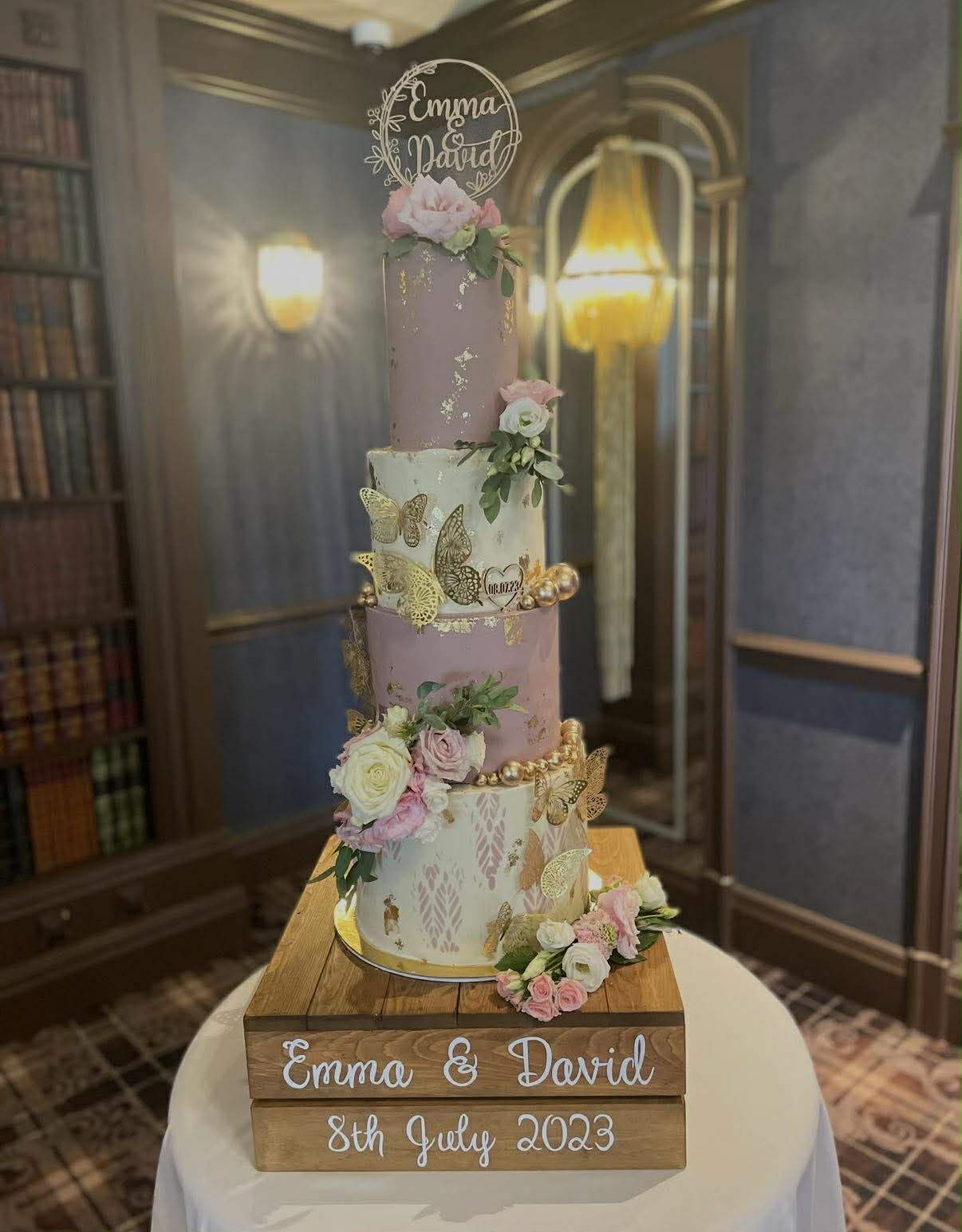 Tiered wedding cake for Emma and David with gold leaf, roses and butterflies